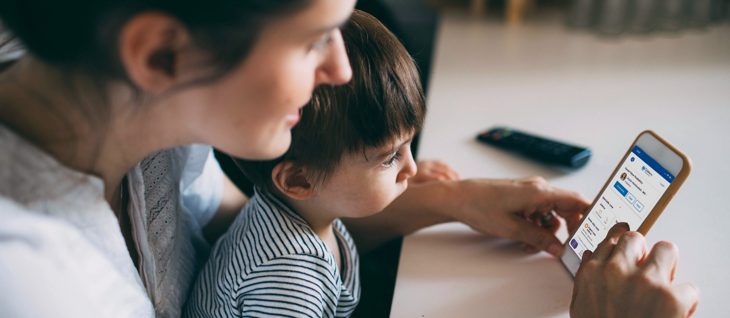 Mother using Children's Wisconsin app with her son