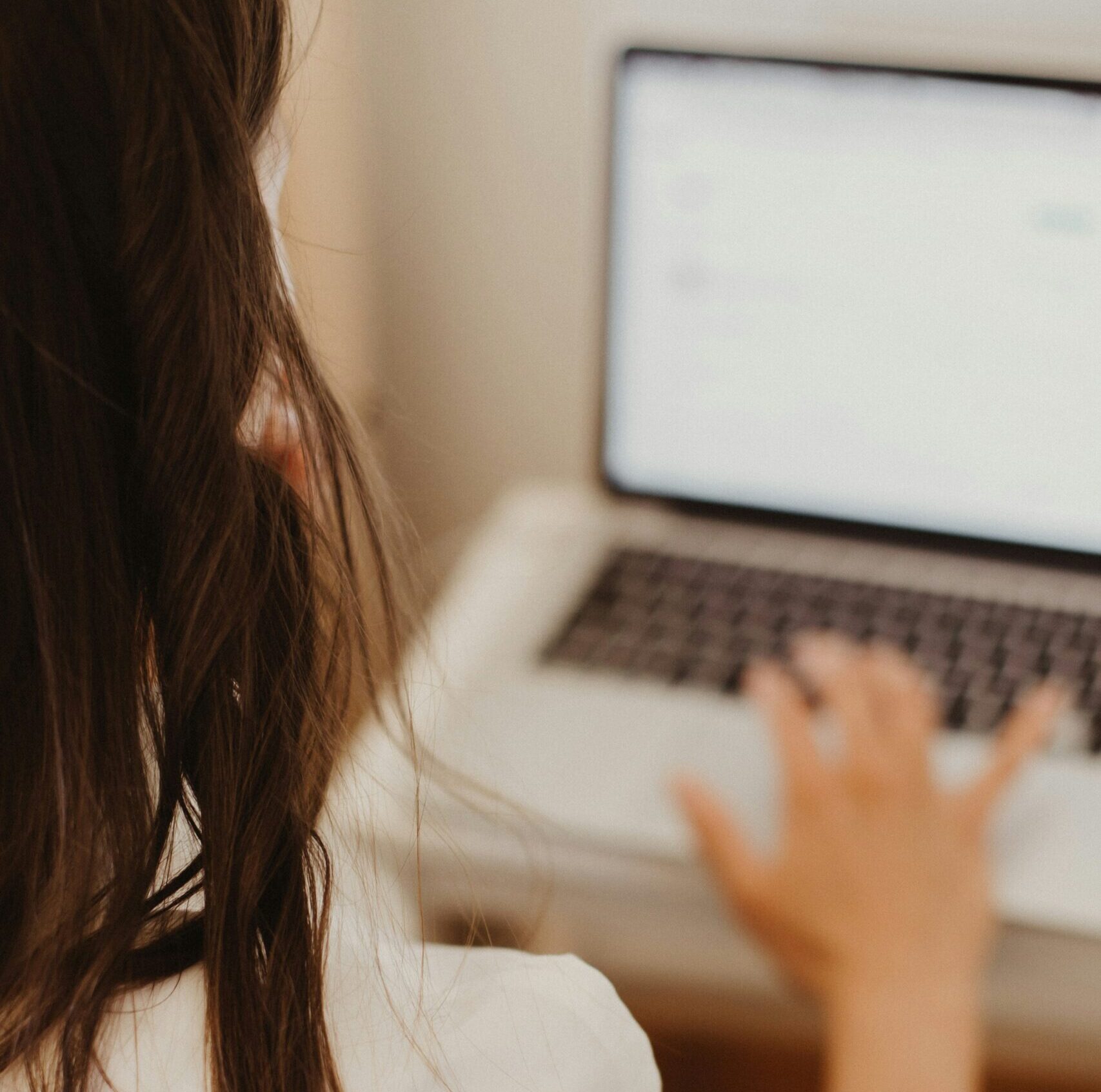 female reading from her laptop