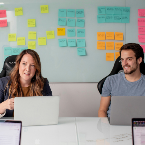 man and woman discussing replatforming in an office