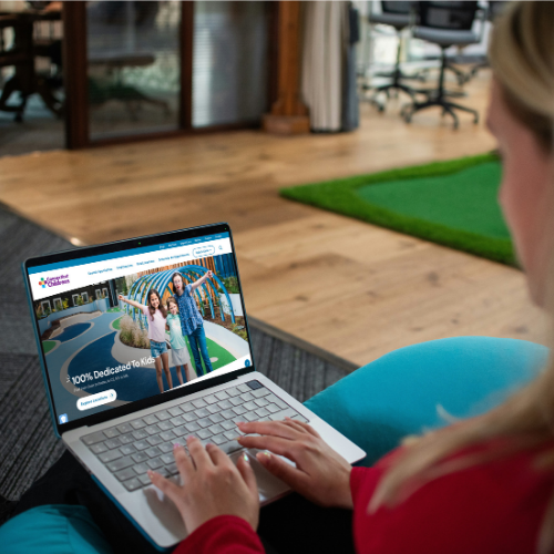 woman looking at Connecticut children's website on her laptop